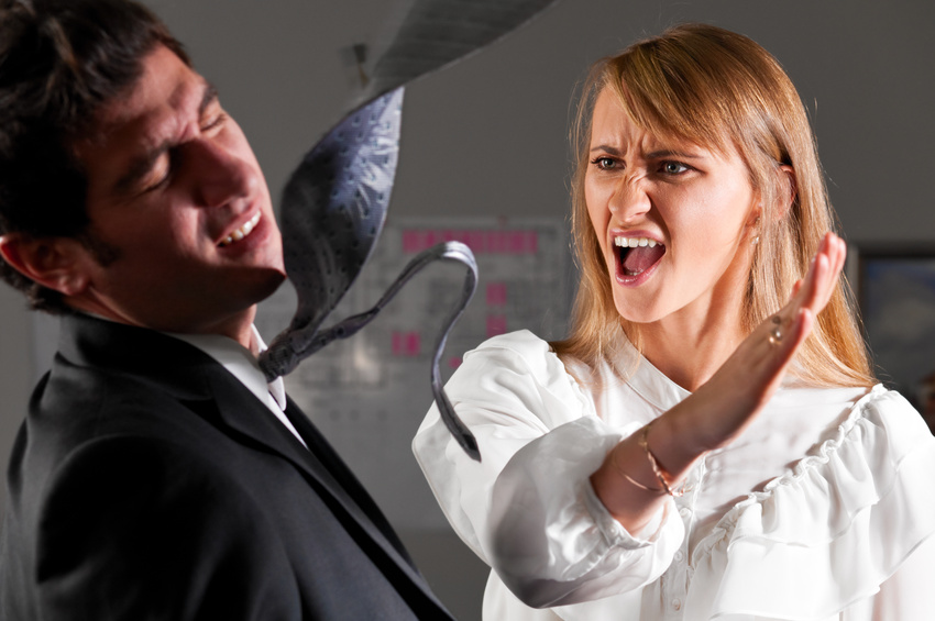 angry businesswoman is slapping across the businessman's face