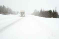 stock-photo-19685401-oncoming-truck-on-snow-covered-road-during-storm